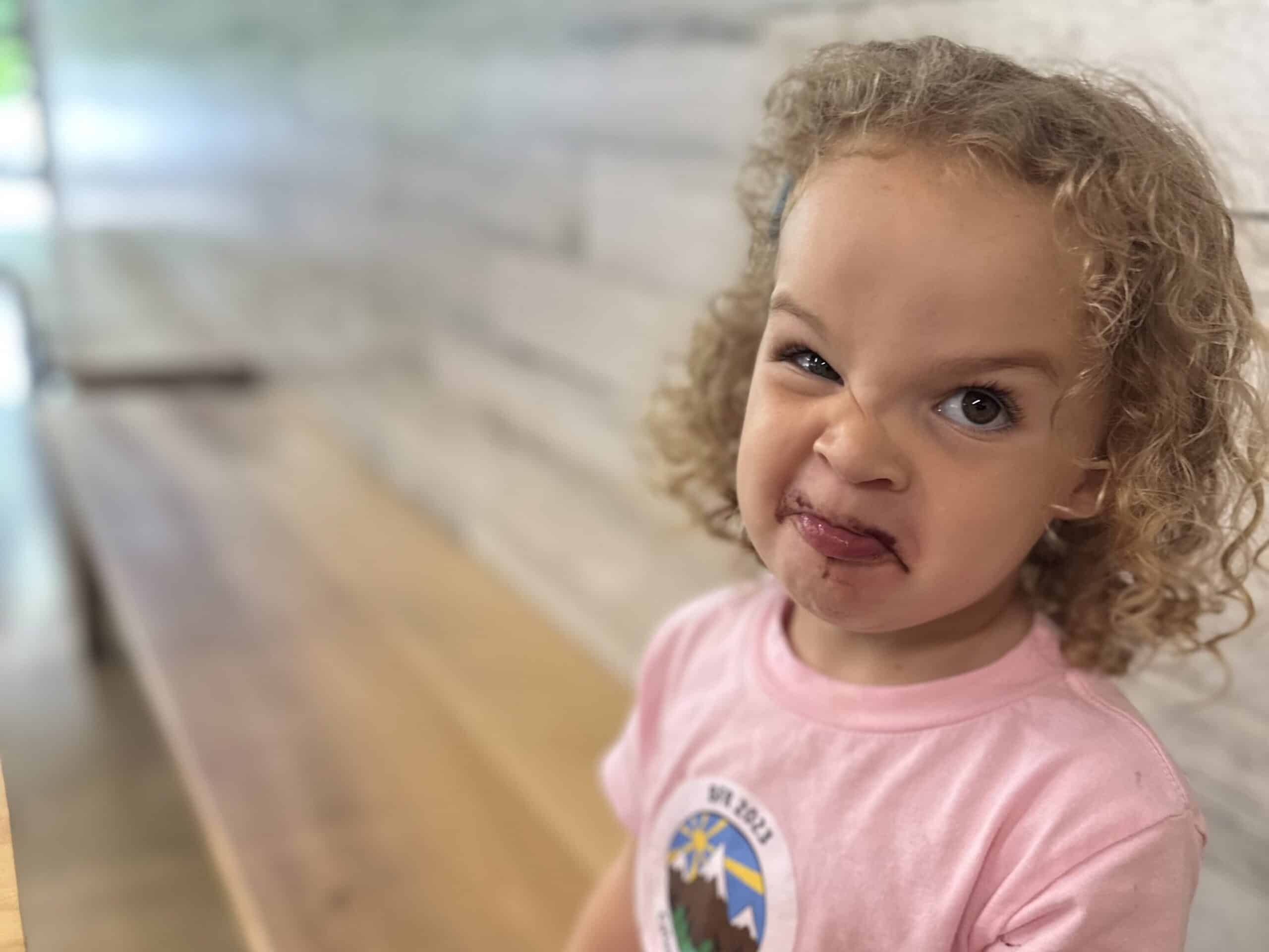 a close-up picture of our high-spirited toddler making a funny face