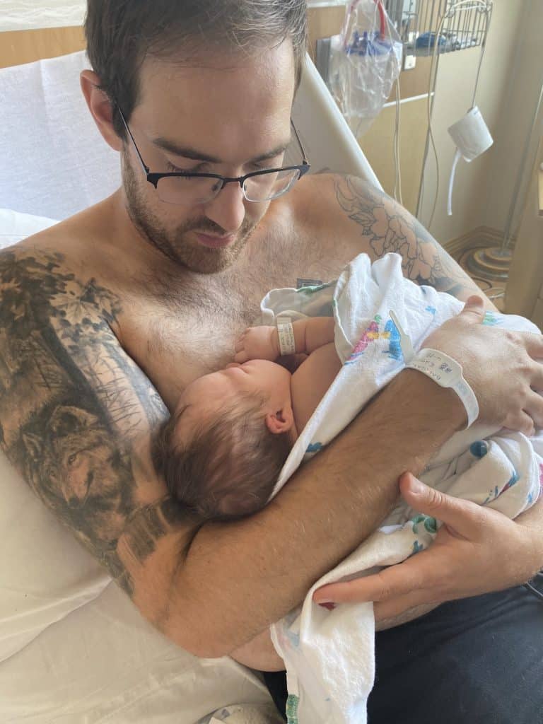 A dad does skin-to-skin contact with his newborn in the hospital