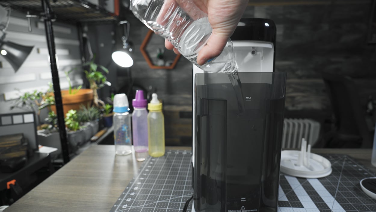 Pouring water into the tank of the Formula Pro Advanced