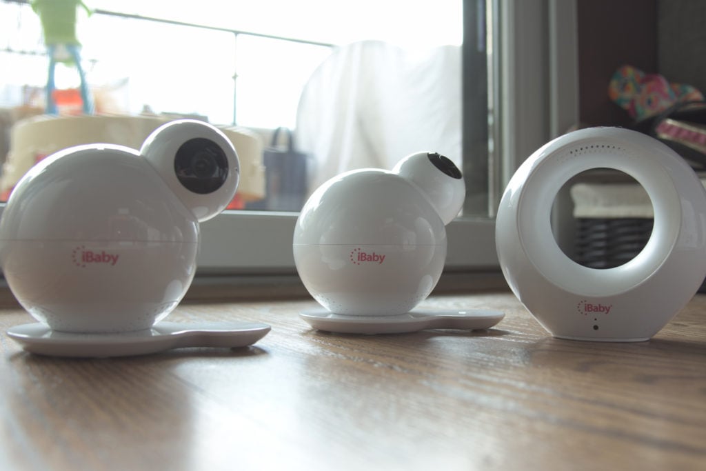 The iBaby M6S, iBaby M7, and iBaby Air sitting on a hardwood floor next to each other