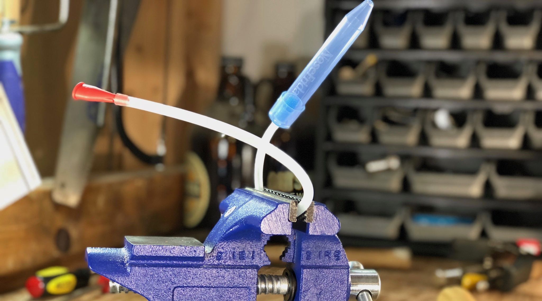 The NoseFrida in a vice grip in a workshop