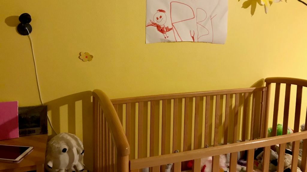 The Nest Cam mounted to a wall above a crib