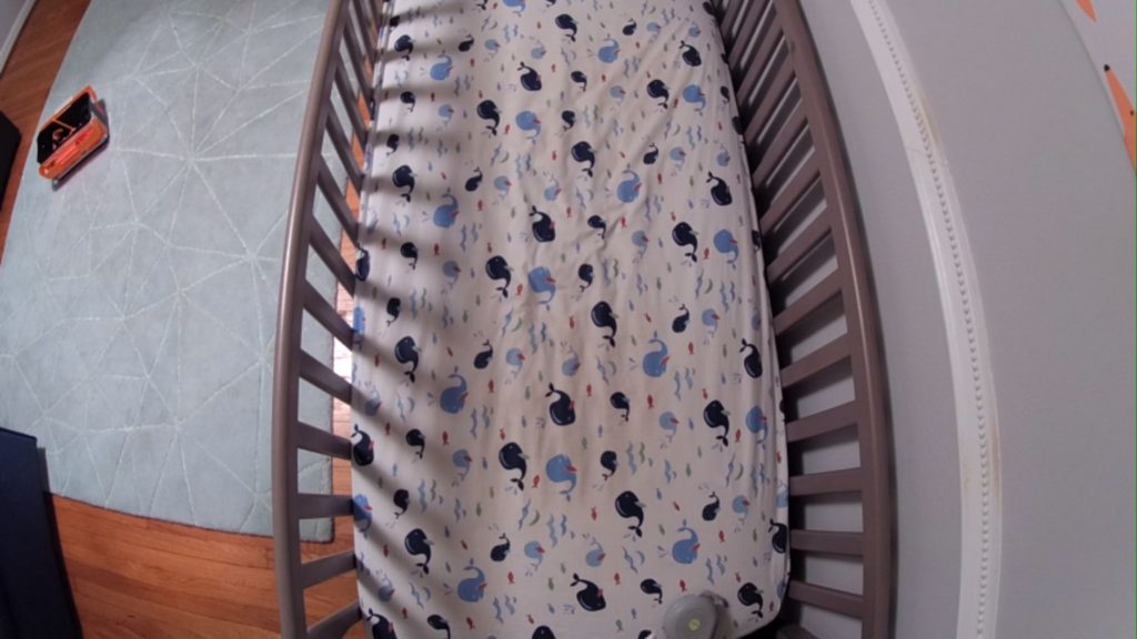 A crib shown in bird's eye view through the Arlo monitor