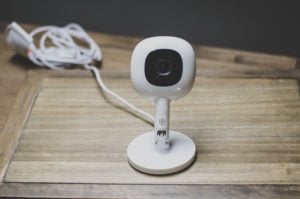 The Nanit camera attached to a wall stand, sitting on a table