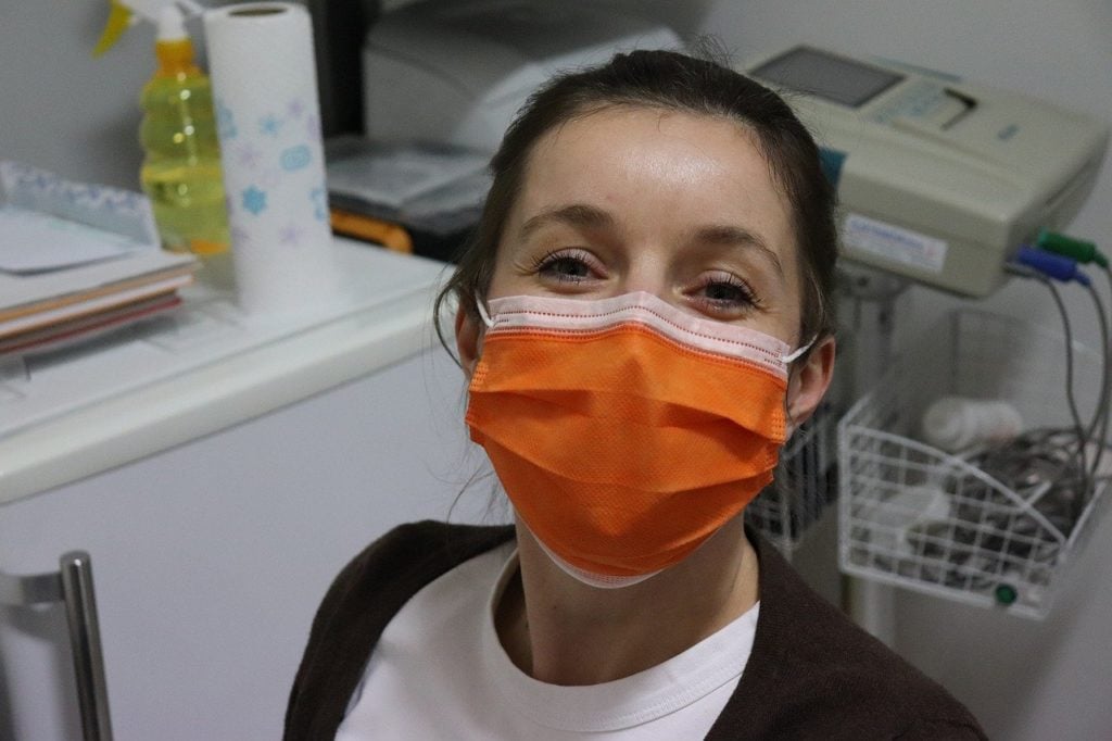 A woman confirming a pregnancy test at the doctor's office.