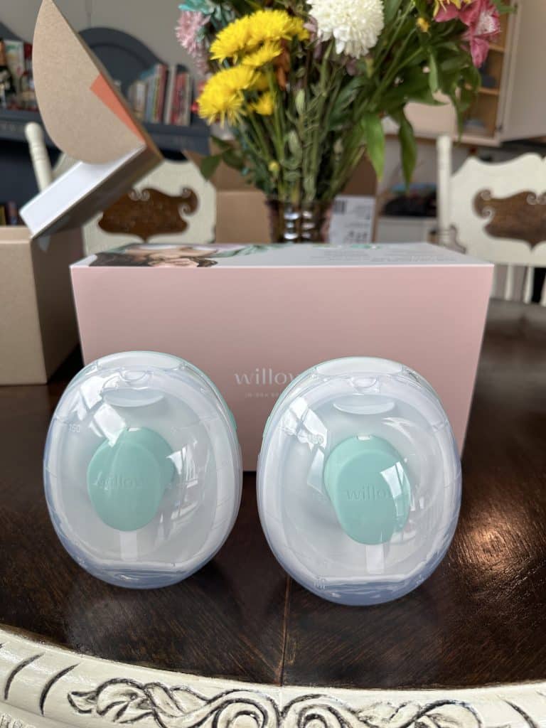 Willow go pumps sit on a table in front of the Willow Go box