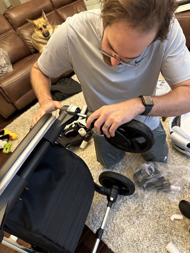 a dad attaches a wheel to the mockingbird