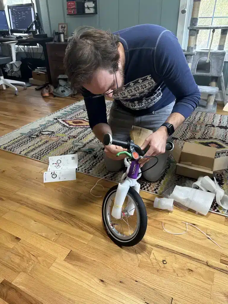 A man (the author) assembling the Woom 1 